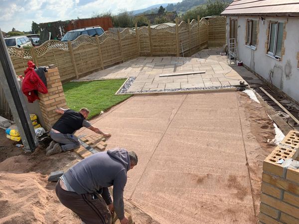 Laying driveway blocks onto the screeded sand bed at another Pontypool home