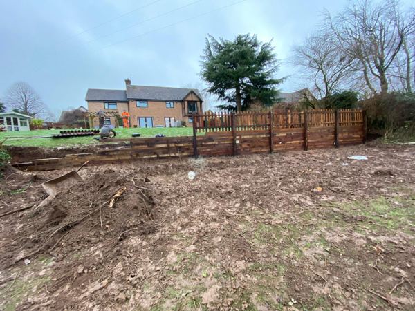 Retaining timbers and picket fence in place, with the ground still being levelled