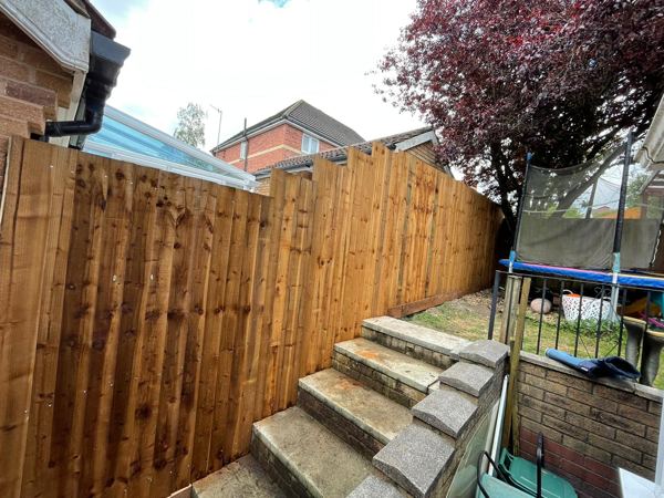 The same steps with a new fence of fresh timber boards