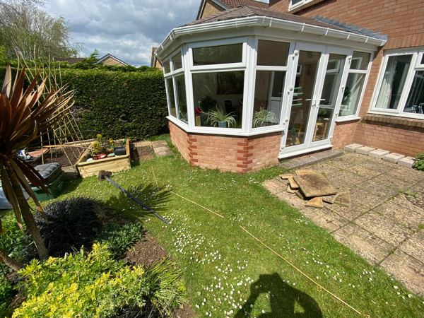 Before: lawn running right up to the conservatory brickwork