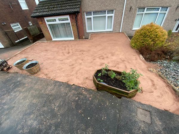 Mid-job: the gravel gone and a level bed screeded out ready for the slabs