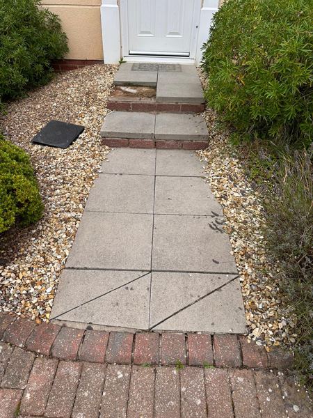 Before: the old grey concrete path with a cracked slab near the pavement