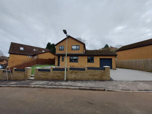 The finished frontage from across the road, wall and driveway complete