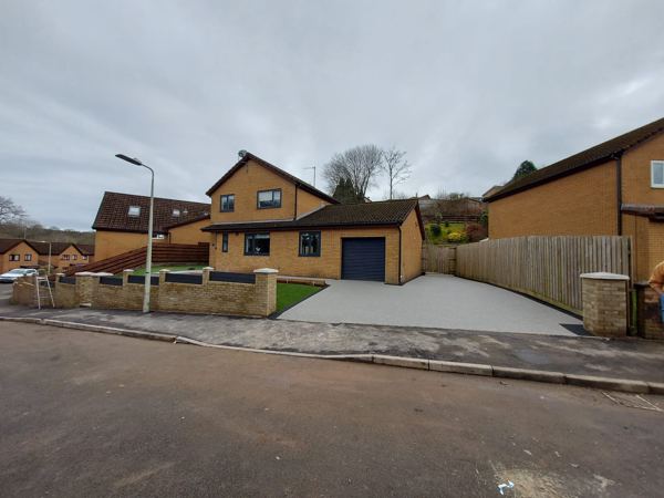 View from the road: new buff brick wall with piers, resin drive behind