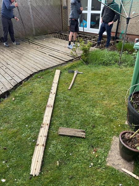 Lifting the old decking boards outside the French doors to reach the frame underneath