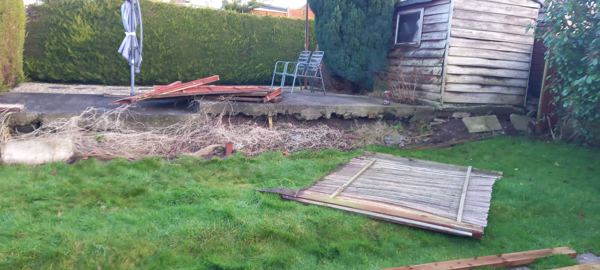 Before: an old lap panel lying flat on the lawn beside the shed and patio