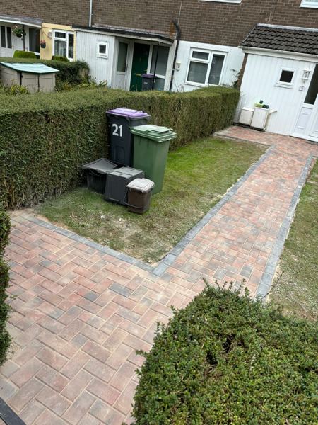 Looking back down the path, with the paved branch to the bin area