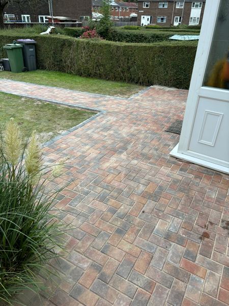 Brindle blocks in herringbone across the front of the house by the porch