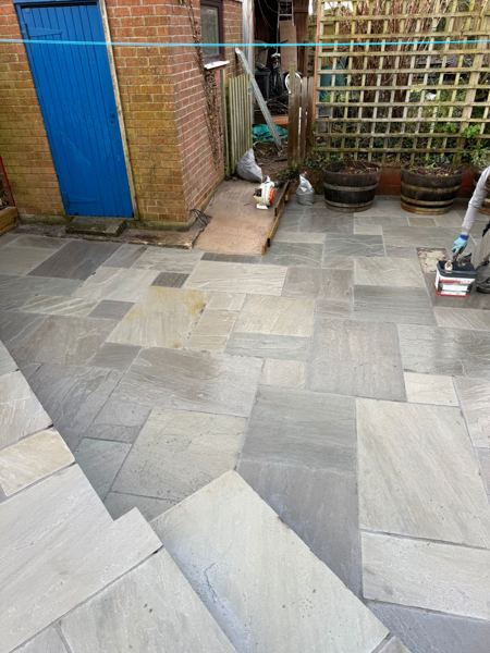 Pointing in progress near the outbuilding and trellis planters