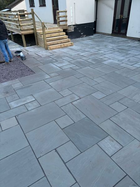 Close view of the random-laid grey slabs leading up to the balcony steps