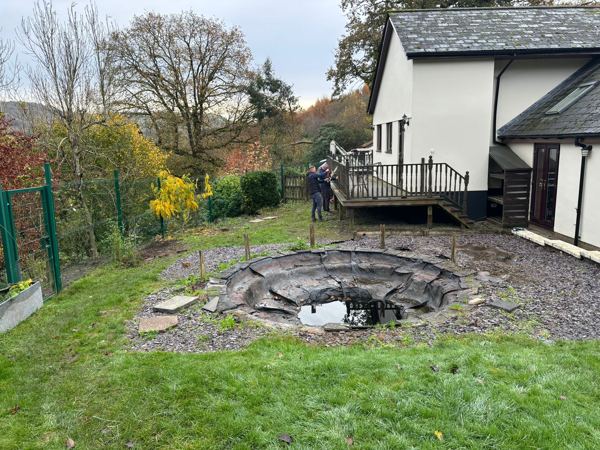 Before: the old sunken pond, slate chippings and the dark-stained balcony