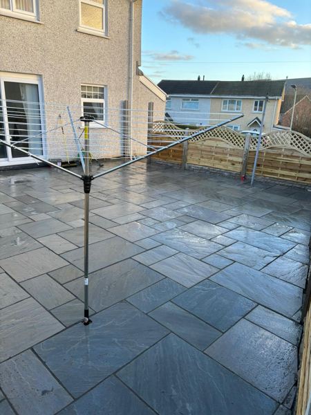 The patio running up to the back door, with the rotary washing line in place