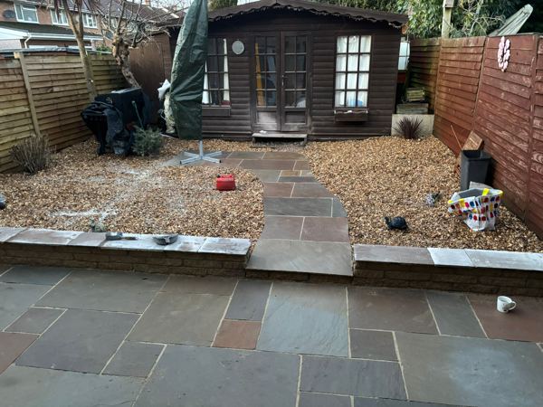 Sandstone step and path running up through the gravel to the summer house