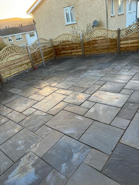 The full width of the patio along the arched lattice-top fence panels