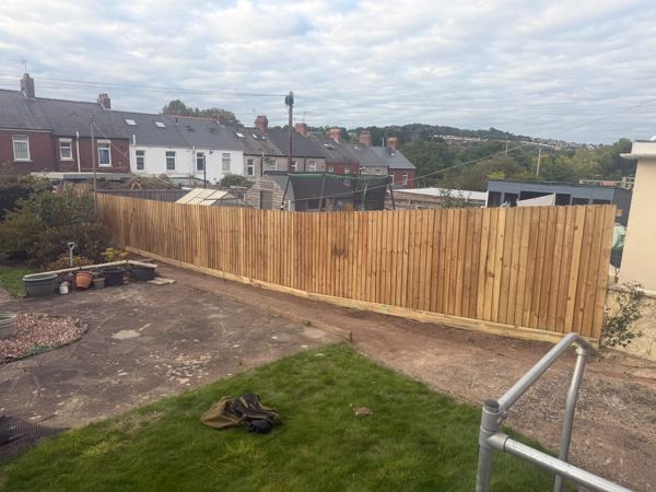 The finished close-board fence running the full length of the garden