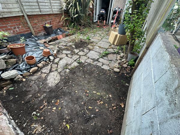 Before: broken crazy paving and bare soil in the narrow back yard