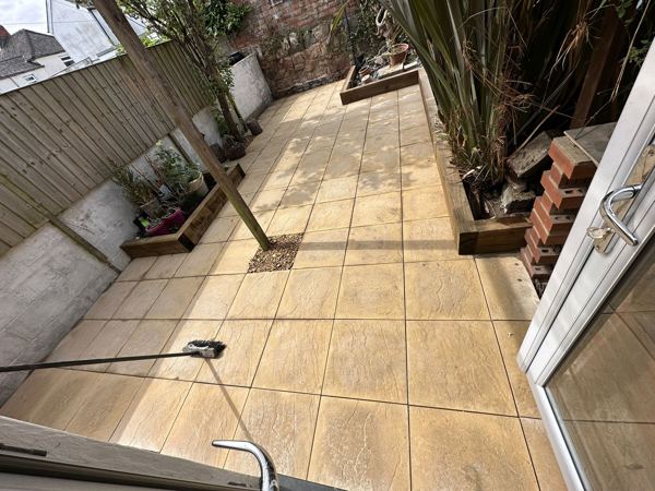 The new buff slab patio, with sleeper-edged beds along both sides