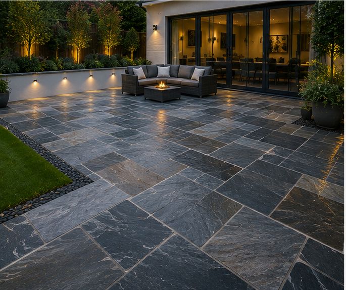 Dark slate-style stone patio with lighting
