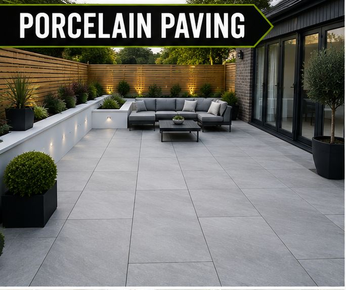 Light grey porcelain patio with a sofa and raised planters