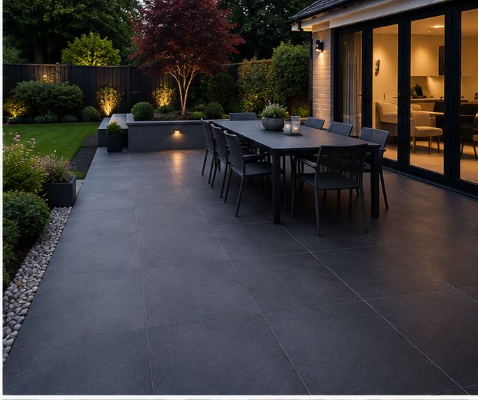 Dark porcelain patio lit at dusk